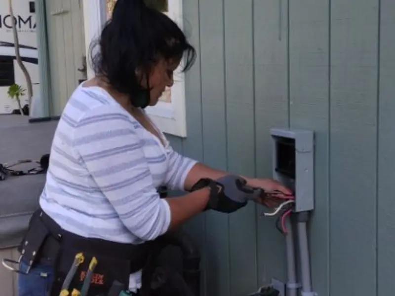 Licensed electrician wiring an exterior subpanel in San Luis Obispo
